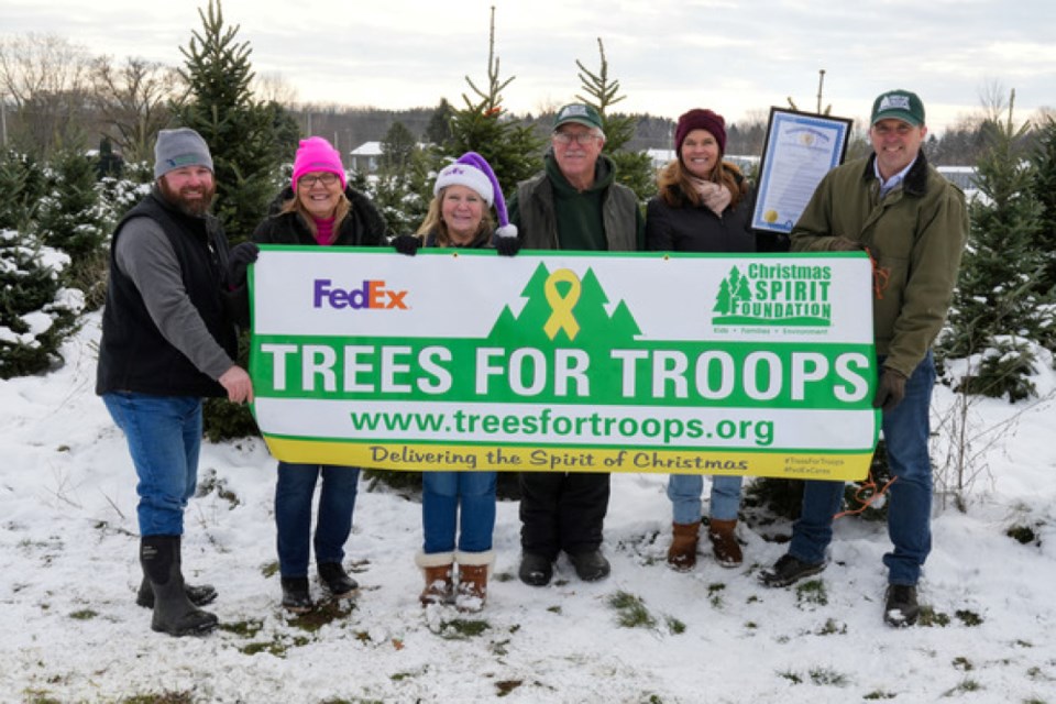 Michigan Department of Agriculture and Rural Development (MDARD) Director Tim Boring and Chief of Staff Kathy Angerer along with representatives from the Michigan Department of Military and Veterans Affairs and Michigan Christmas Tree Association participated in a Trees for Troops event at Wahmhoff Farms in Gobles