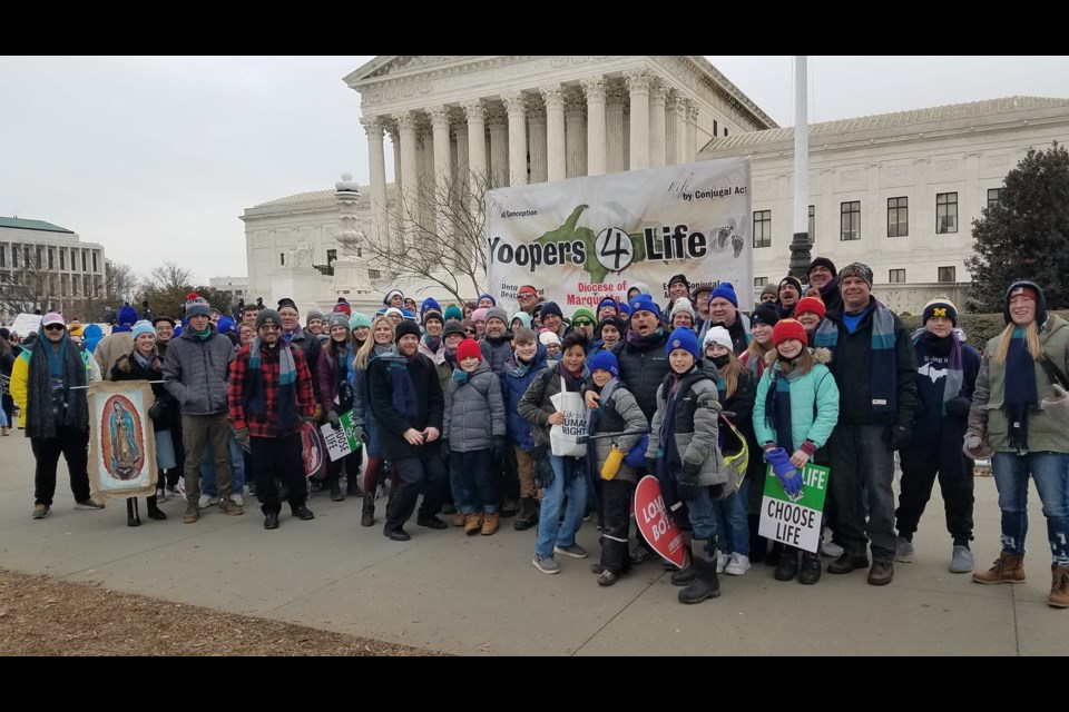 Pro-life pilgrims from the Diocese of Marquette stand in front of the Supreme Court in Washington D.C. after completing the March for Life on Friday, Jan. 21, 2022. Diocesan marchers carried pro-life signs, a "Yoopers for Life" banner, and images of Our Lady of Guadalupe