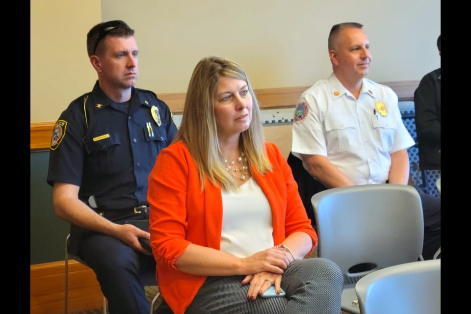 Sault Ste. Marie City Police Chief Wesley Bierling, Sault Area Public Schools Superintendent Amy Scott Kronemeyer and Sault Ste. Marie Fire Chief Ed Miller seated at city commission meeting