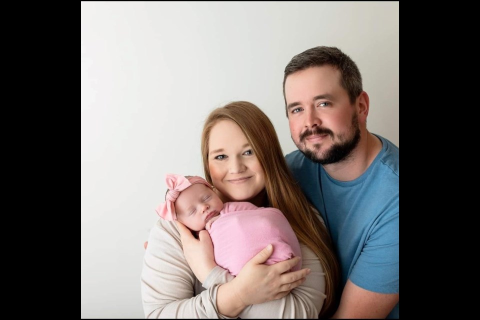 Calvin and Kara Wilson holding their baby girl, Caroline