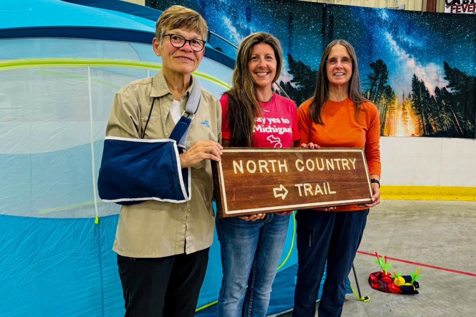 North Country National Scenic Trail hikers Jane Norton (left) and Jane Langeland (right) stand with Heather Johnson Durocher of the Michigan Department of Natural Resources during the annual celebration in St. Ignace.