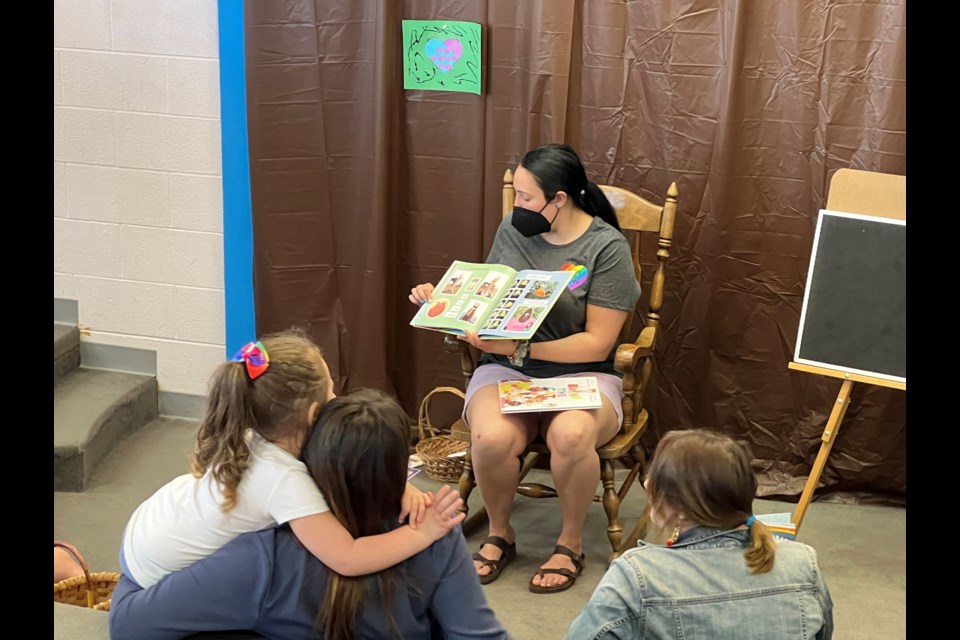 Bayliss Public Library Librarian Sabrina Neveu reads to kids during Pride Storytime event on Tuesday 