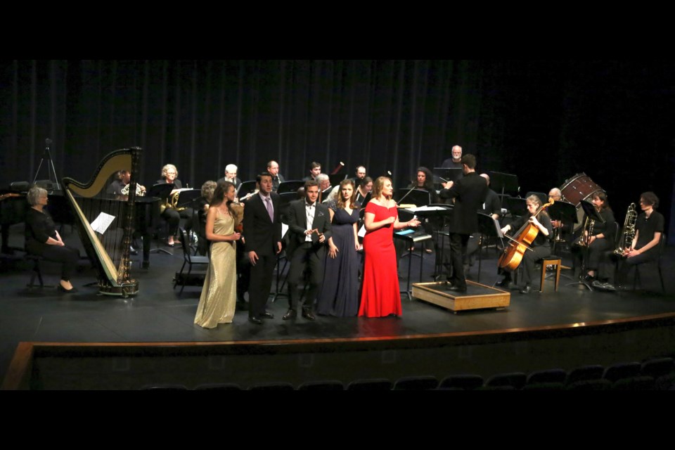 Five La Bohème cast members with its orchestra at Lake Superior State University Arts Center Thursday, Aug. 11