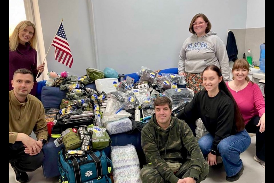 Jenny Stoudt (far right in pink shirt) with supplies.