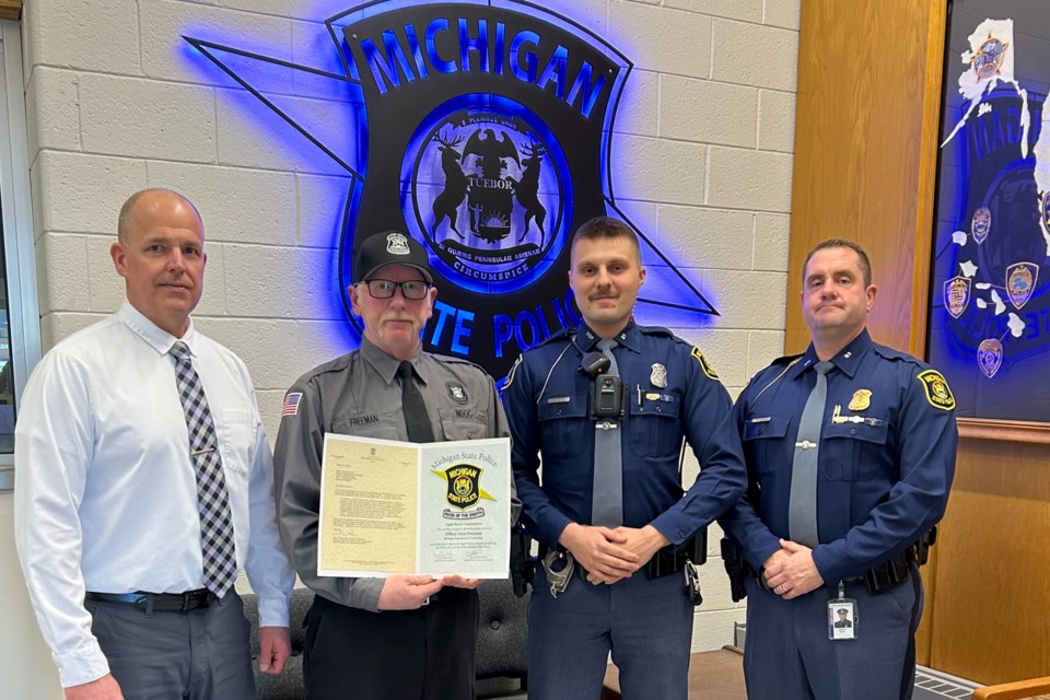 Left to right: Acting Warden of the Alger Correctional Facility Doug Tasson, Officer Freeman, Trooper Jenich and Negaunee Post Commander Tom Nolan