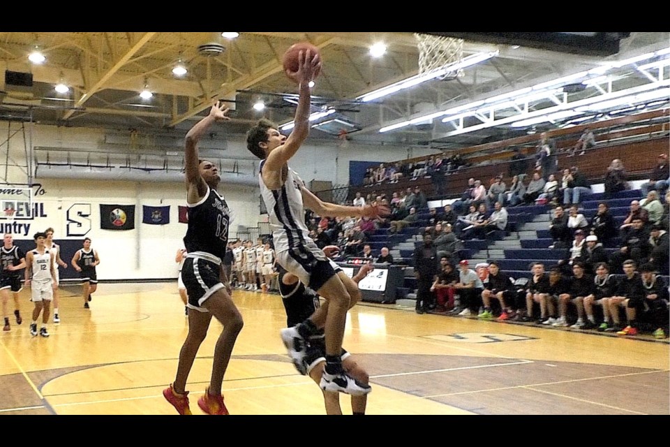 Carter Oshelski goes in for the lay up for Sault High in first quarter action.