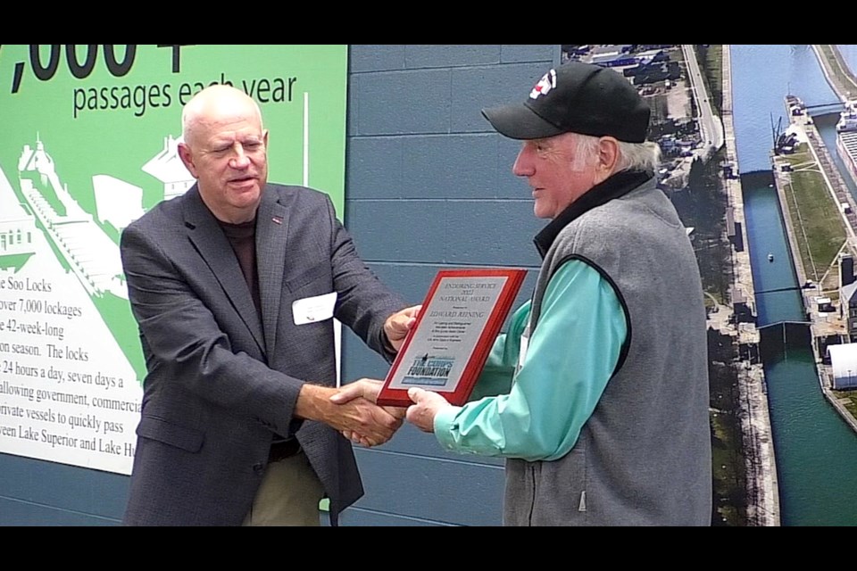 Ed Reining was honored for his two decades of volunteer service at the Visitors Center inside the Soo Locks Canal Park