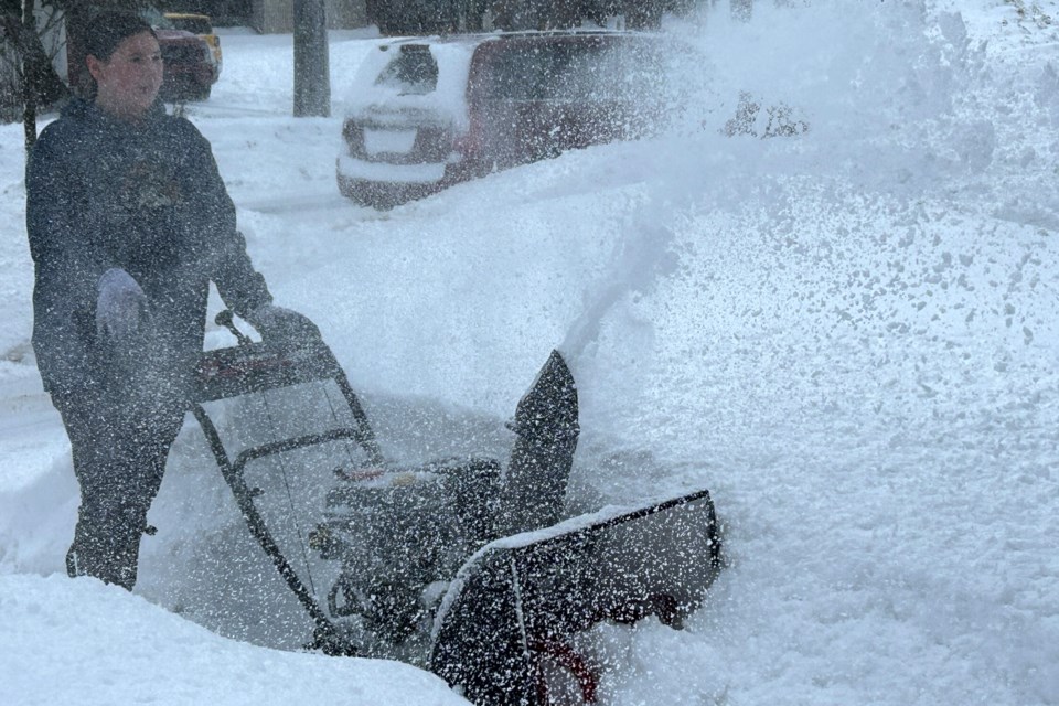 Molly Escherich clears driveways and sidewalks to earn money to purchase music equipment.