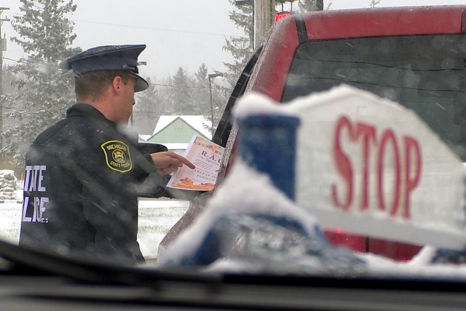 Troopers from Post 82 in Sault Ste. Marie handed out certificates for free turkeys as part of their Random Acts of Kindness - Law Enforcement Edition.