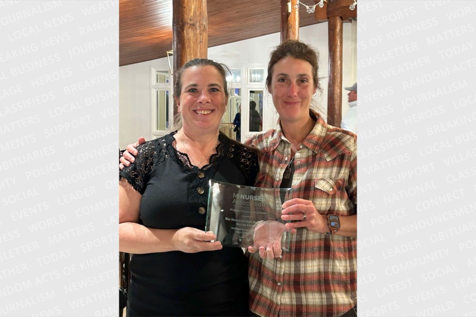 Colleen Waucaush (L) and Stacie Duchin (R) hold the Hall of Fame plaque awarded to the MNA MyMichigan union nurses