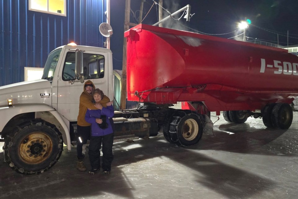 Scott LaCoursiere, his mother, JoAnn, and son, Austin, all volunteered Wednesday evening to help build up ice on the I-500 track.