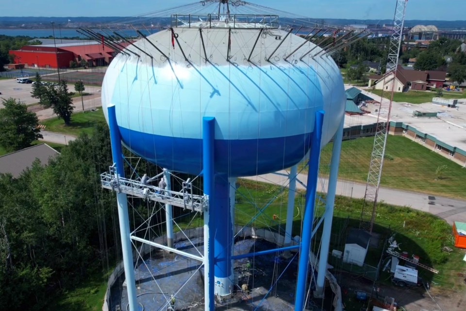 Work continued today on the water tower in Sault Ste. Marie as workers lay down a coat of blue paint.