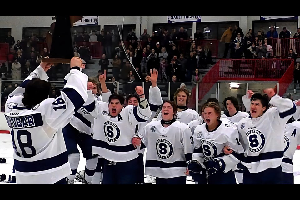 Jay Dunbar holds up the Region 18 trophy.