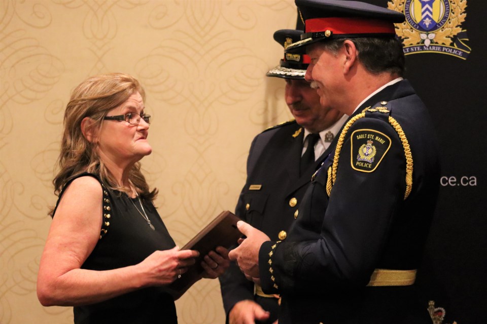 Save Our Young Adults founder Connie Raynor-Elliott receives an award for their contributions to the community at the 35th annual Police Community Programs Night on May 16, 2023.