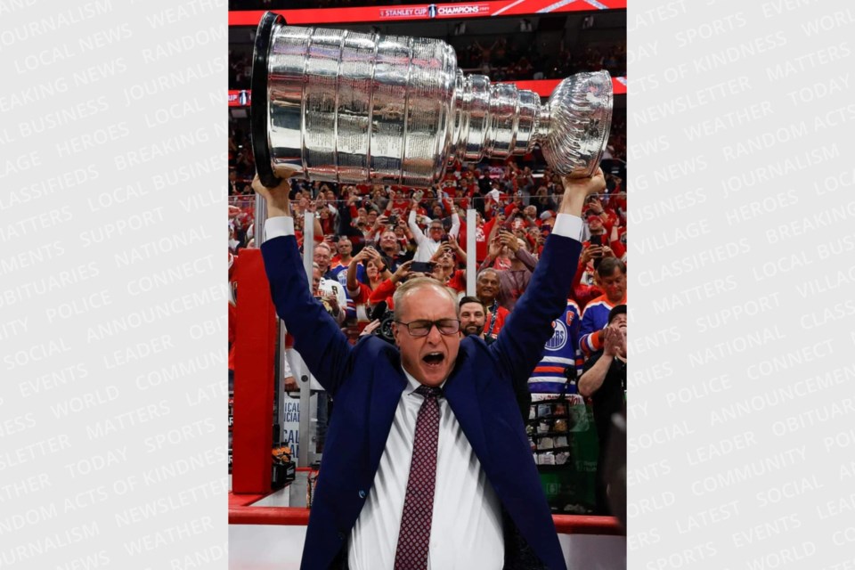 Paul Maurice lifts the Stanley Cup over his head just moments prior to phoning his parents back in the Sault.