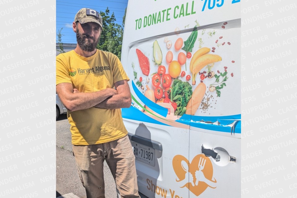 A disappointed Jeff Socchia stands next to Harvest Algoma's all-important cargo van, which had its back door handle ripped off during an attempted break-in earlier this week.