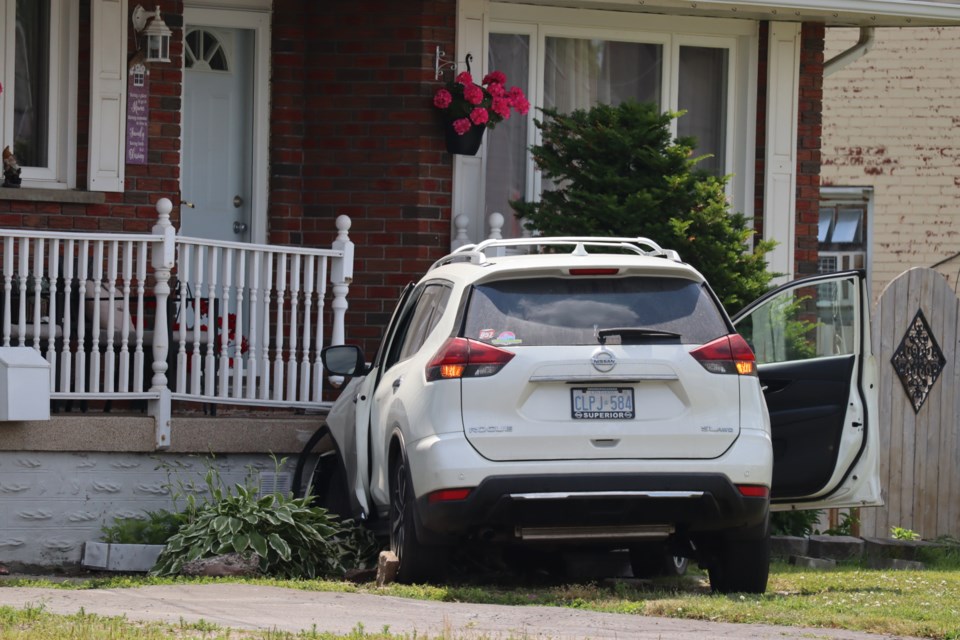 After colliding with a west-end house, a motor vehicle faces serious damages to its front-end and driver's side.