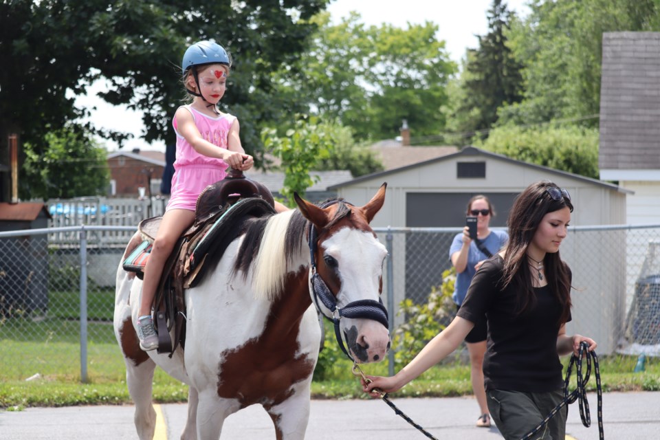 Families gathered in the parking lot at Cornerstone Seventh-day Adventist Church for an afternoon of free food and games on Sunday.