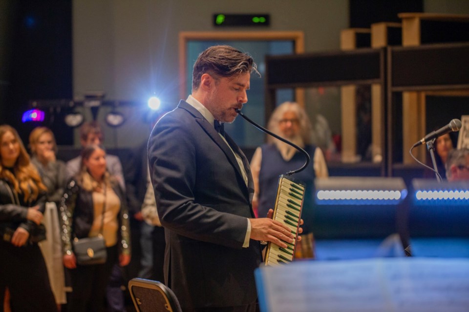 Jeff Toyne, pictured playing a melodica, will have two chances to win an Emmy next month for his musical writing and composition on the Apple TV+ show 'Palm Royale'