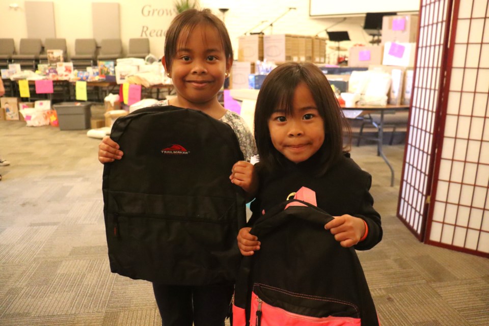 Children of all ages received a free backpack just in time for the upcoming school year during a charitable barbeque event hosted by Destiny Christian Centre on Saturday.