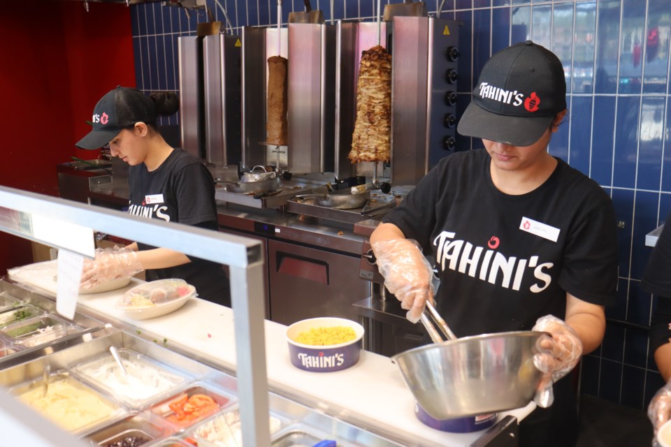 Employees at the newly opened Tahini's restaurant are hard at work as they celebrate their first week in operation at the Churchill Plaza.