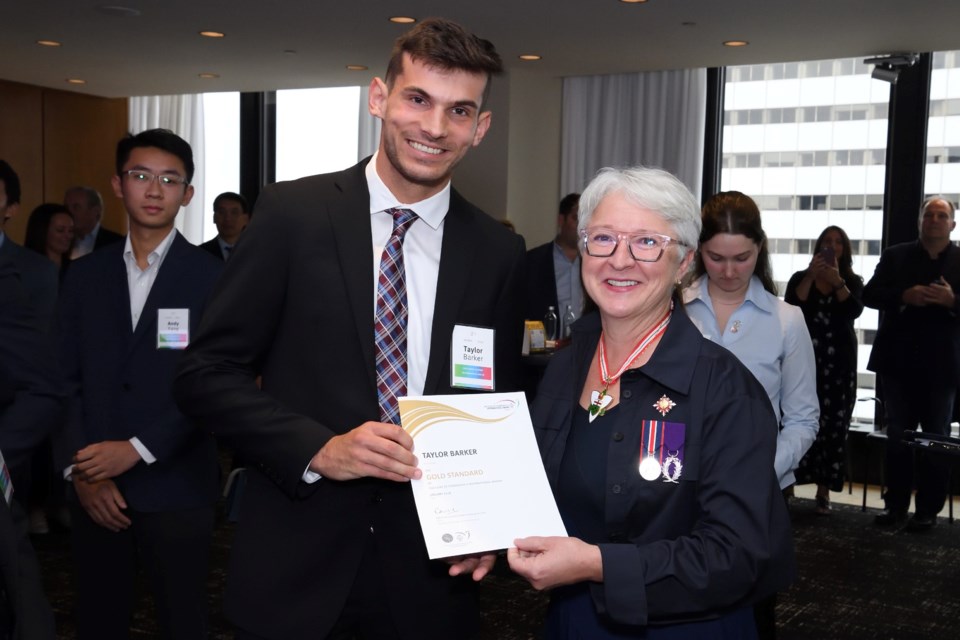 Korah Collegiate graduate Taylor Barker receives his Duke of Edinburgh Gold Level certificate from Lieutenant Governor Edith Dumont during a special ceremony in Toronto on Aug. 16, 2024.