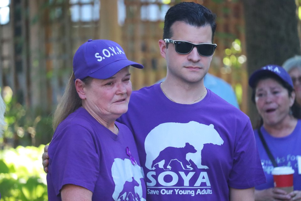 SOYA founder Connie Raynor-Elliott is consoled by Mayor Matthew Shoemaker during Overdose Awareness Day ceremony at the Memorial Wall on Aug. 31, 2024.