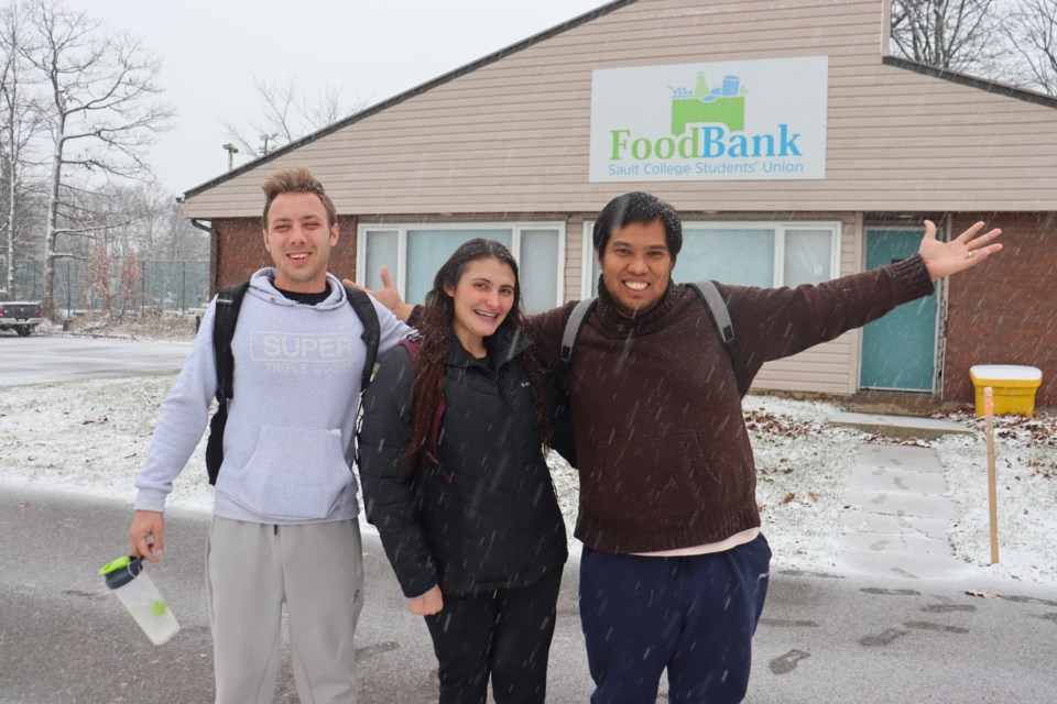 Sault College students Joshua Villeneuve (left), Haley Moskal (middle), and Michael Angelo Realista (right) were among five classmates who donated more than 2,700 non-perishables to their school's food bank this month.