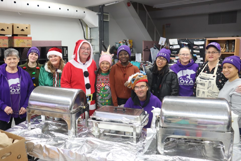 A group of joyful volunteers at SOYA's Gore Street depot handed out 300 Christmas dinners and stockings to the less fortunate on Dec. 16, 2023.