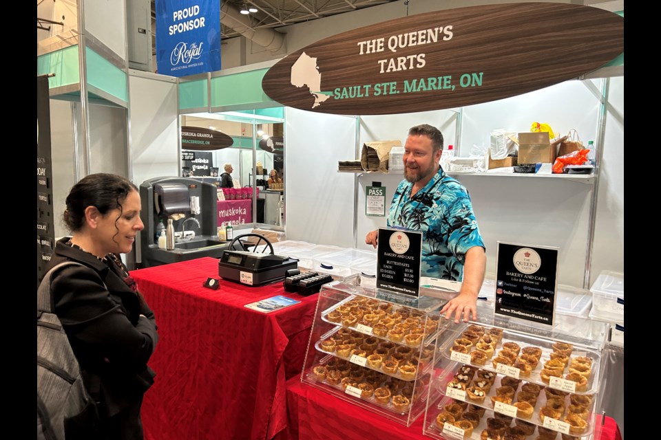 FedNor President Valerie Gideon discusses the importance of local food providers with Aaron Craig of The Queen’s Tarts during a tour of the Northern Ontario Agri-Food Pavilion in Toronto