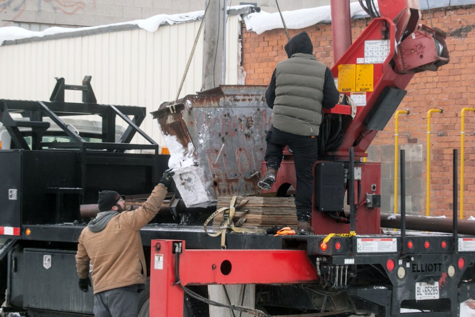 The iconic Victor Mann Florist sign that hung for decades on King Street at the back of the store was removed Tuesday.