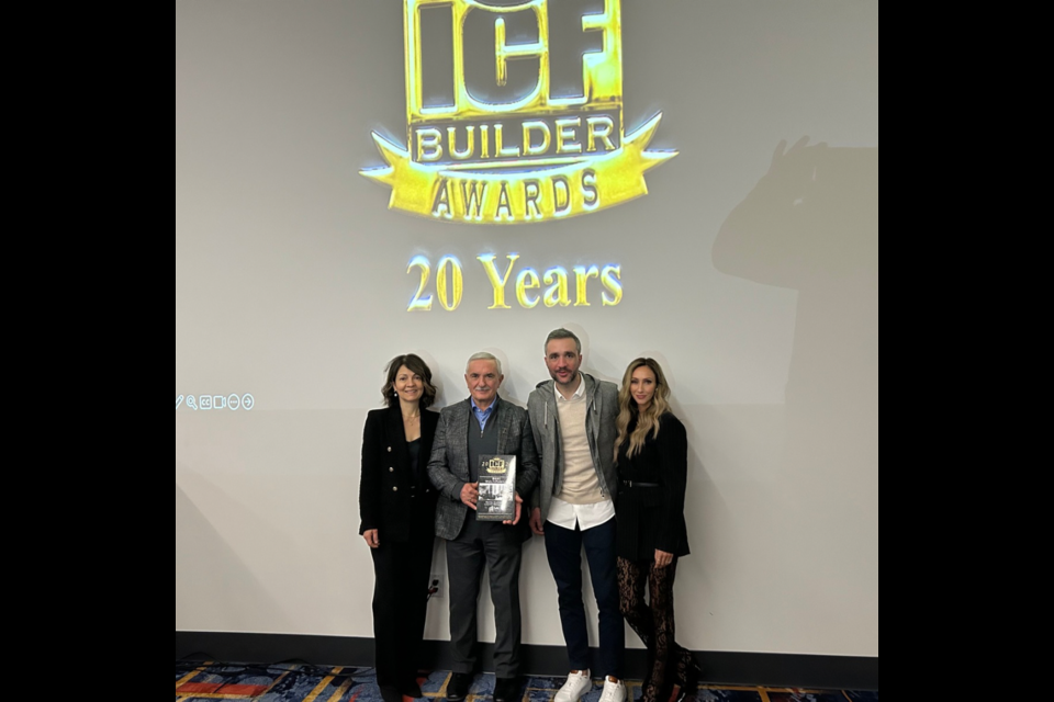 Sam and Joey Biasucci collecting the award with their wives in Las Vegas 