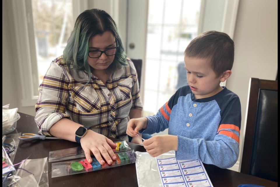 Calvin (right) and his mom Lindsay (left) put the finishing touches on an Easter order.