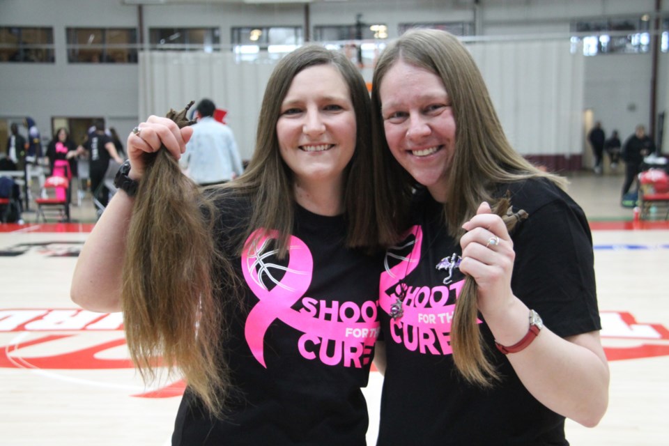 Debra Meades and Megan Parlowe had several inches of their hair snipped by Sault College hairstylist program students at a Shoot for the Cure fundraiser for the Canadian Cancer Society held at the George Leach Centre, Jan. 25, 2025.