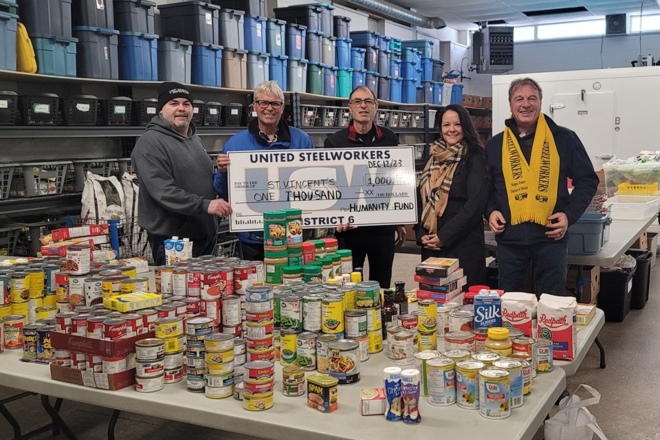 Taking part in the cheque pass are Andrew Notte, USW Local 8748 recording secretary (left), Marc Ayotte, USW District 6 area coordinator, northwestern region, Nat Cicchelli, St. Vincent Place general manager, Melissa McMaster, USW Local 2724 recording secretary and Joe Krmpotich, USW Local 2251 union coordinator