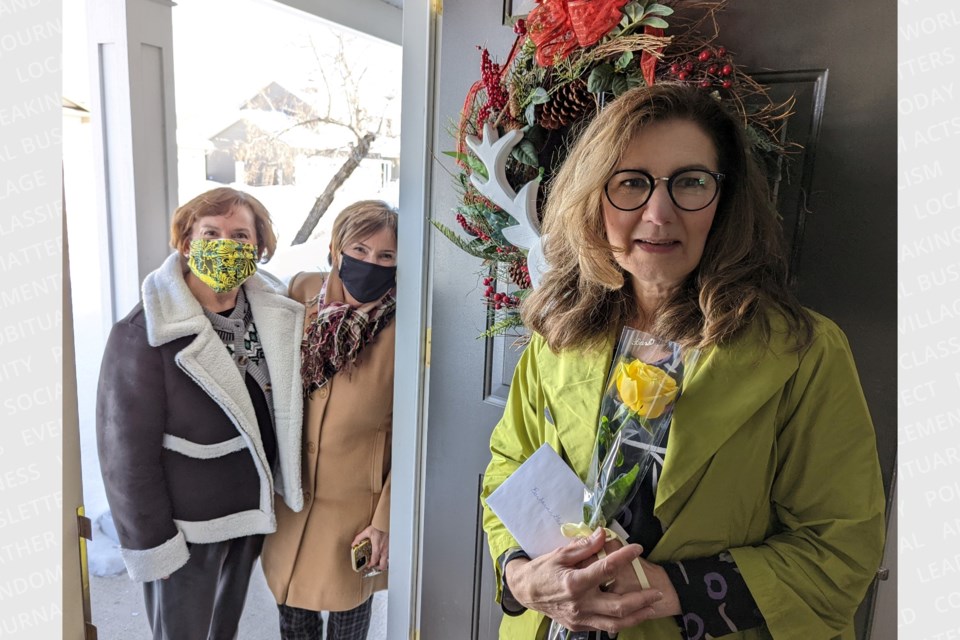 Barbara Gallagher is presented with a yellow rose.