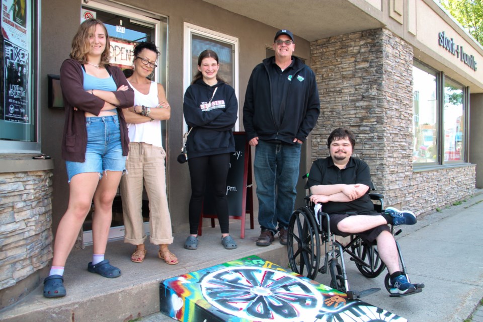 White Pines students Aurora Huffels and Ulannah Sarrasin with The Rad Zone manager Melodie Taylor, White Pines teacher Scott MacDonald and son Benny MacDonald with a newly installed accessibility ramp for customers with mobility issues, August 13, 2024.