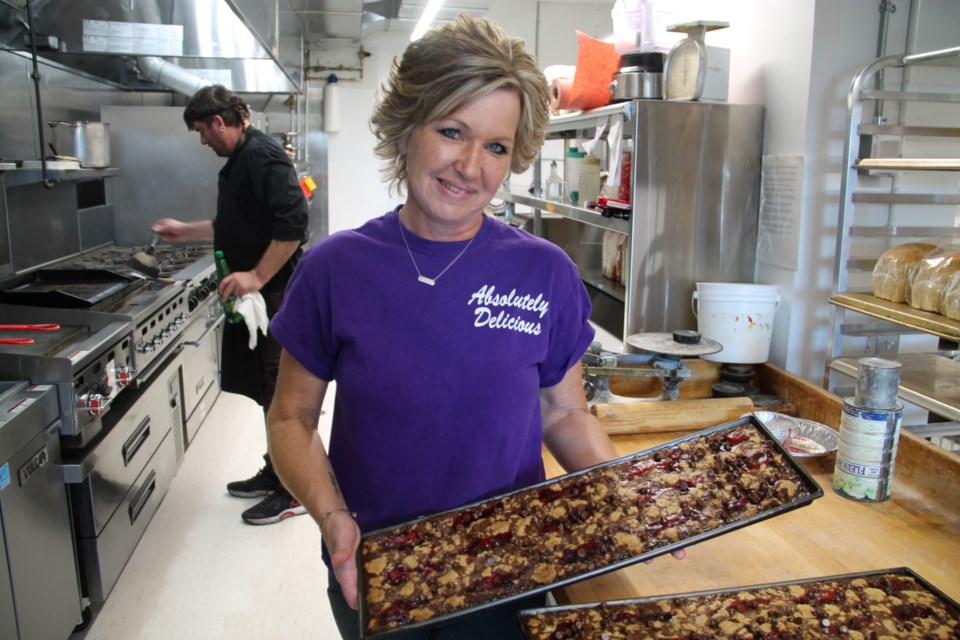 Absolutely Delicious owner/operator Angelisa Mills with homemade chocolate raspberry squares at her restaurant’s new location at Royal Canadian Legion Branch 25, Oct. 10, 2024. 