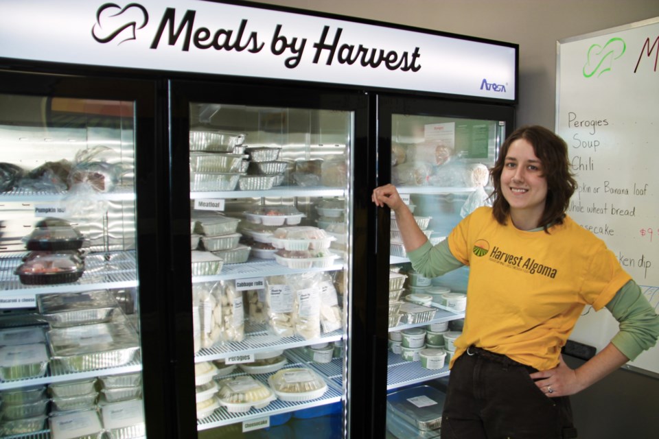 Lauren Moran, Harvest Algoma’s community enterprise manager, pictured with a freezer full of fresh, professionally-prepared meals available for purchase from Meals by Harvest, Feb. 11, 2025.