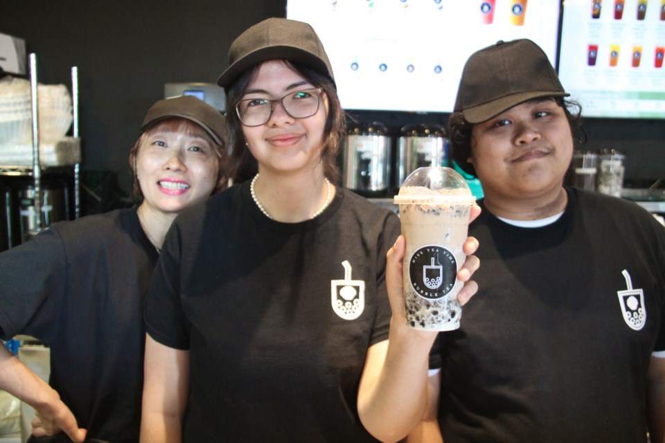 Alexis Tong, Miss Tea Time employee (centre) with a brown sugar cream Oreo bubble tea with Miss Tea Time manager Hatsumi Matsubara (left) and fellow employee Jmuel Alcala (right), July 16, 2024.