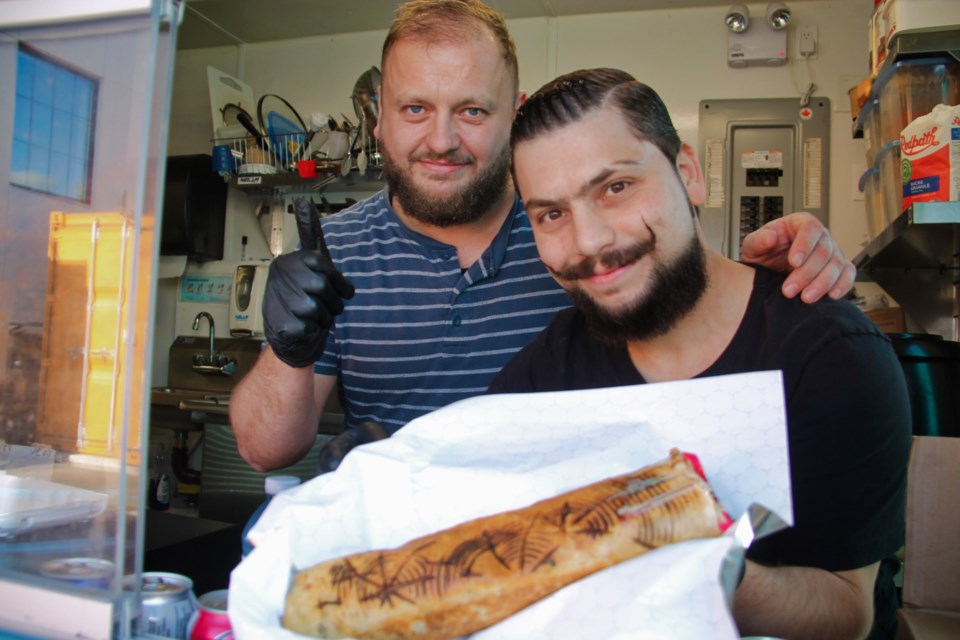 Syrian Table co-owners Alaa Oughli and Bassam Hamza enjoy preparing and selling Syrian shawarma and lentil soup to customers.