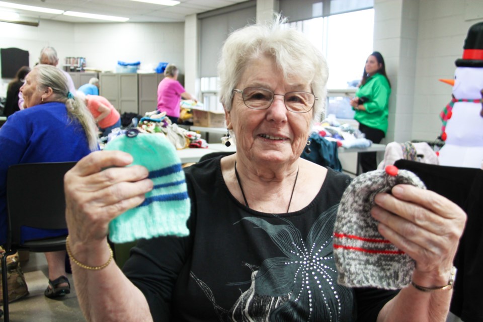 Deina Rouse with hats she knits for newborns, Nov. 20, 2024.