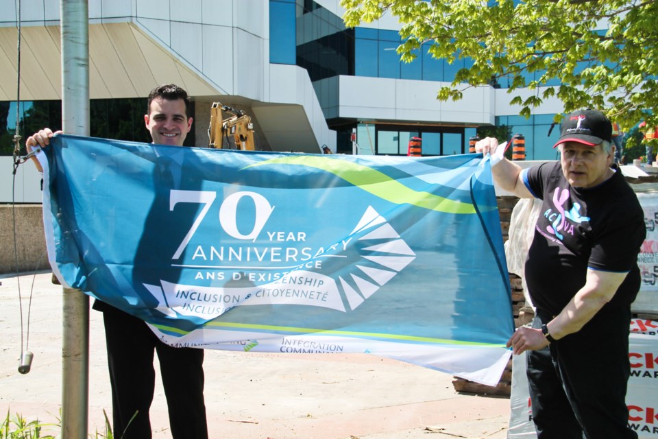 Sault Mayor Matthew Shoemaker and Wawa-based Gordon Draper, Algoma Community Vision Advocates chair at a 70th anniversary flag raising ceremony for Community Living at the Civic Centre, May 24, 2024.