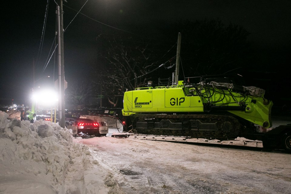 A GIP-branded Liebherr 950 Demolition Litronic was being carried by a flatbed to the old hospital site when the cab was trapped in a snowbank.