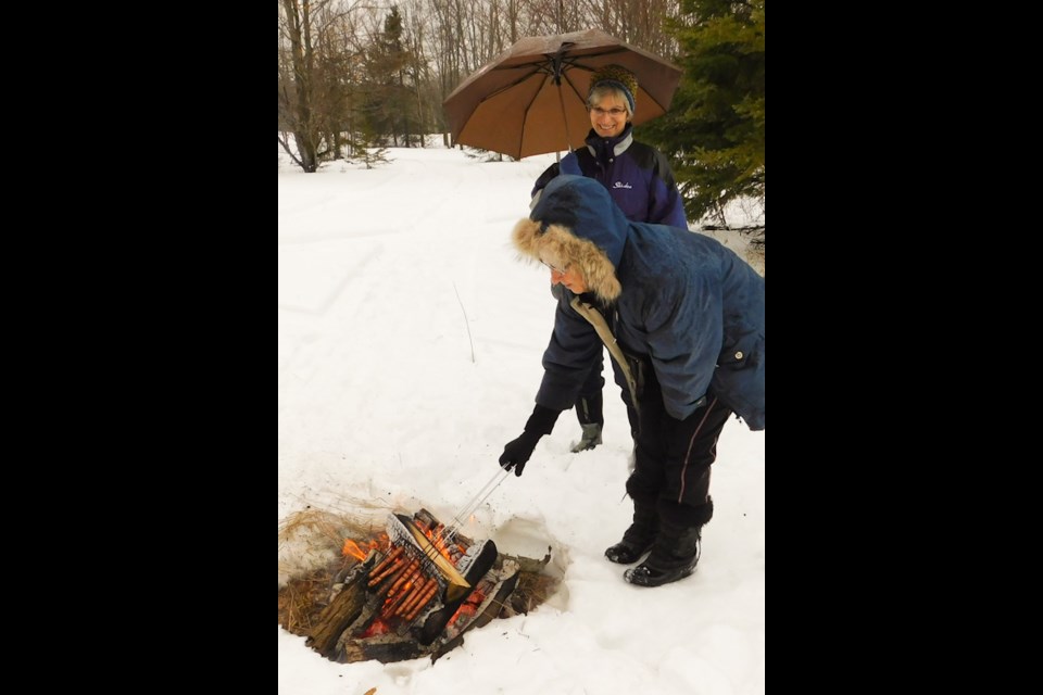 Light snack of a freshly warmed hot dog over an open fire tempt the palate of the young and young at heart during the Annual Snowday, Sunday hosted by the Jocelyn Township recreation committee. Donna Schell for SooToday