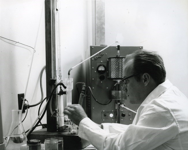 Lab tech working in sinter plant laboratory to check chemistry of ore samples – 1965. Sault Ste. Marie Public Library archive photo