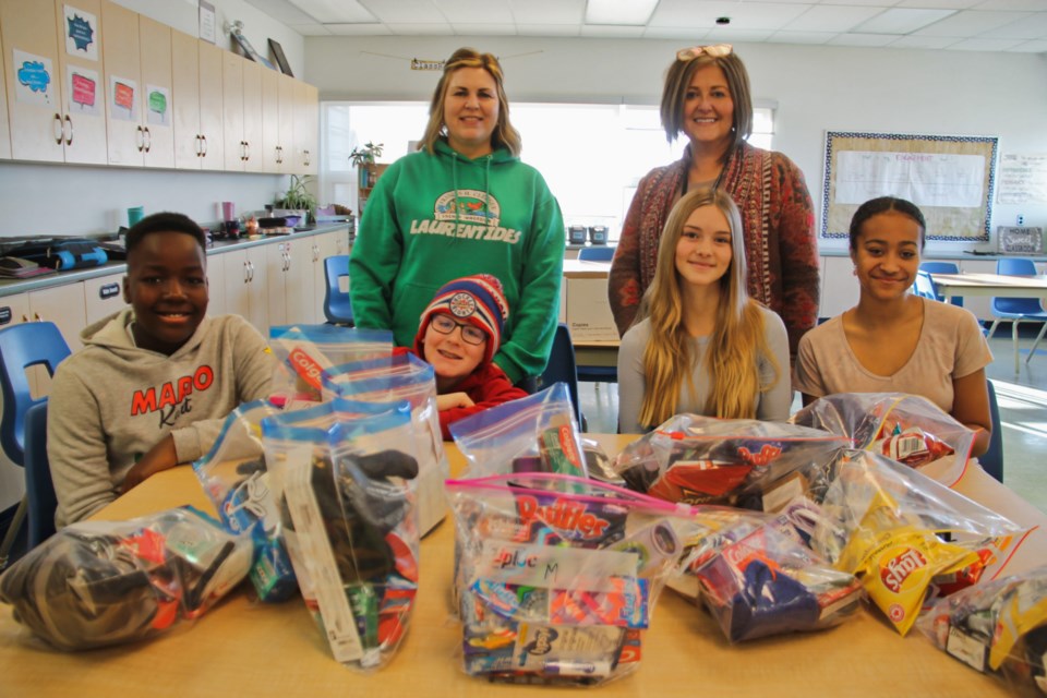 F.H. Clergue Public School students Praise Shima, Chase Miron, Olivia Anthony and Emily George, pictured with teachers Stacey Verbonac and Elvezia Panco, with Blessing Bags stuffed for SOYA clients, Dec. 19, 2023.