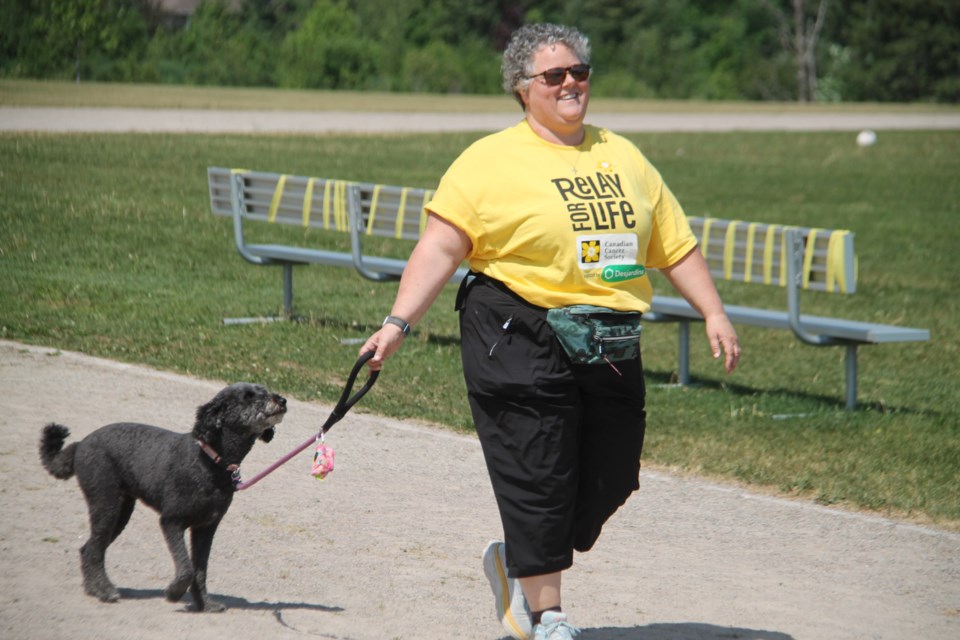 Stephanie Parniak, St. Mary’s College chaplain and cancer survivor, joined by her dog Ellie, participated in the school’s first relay for life event, June 9, 2023. 