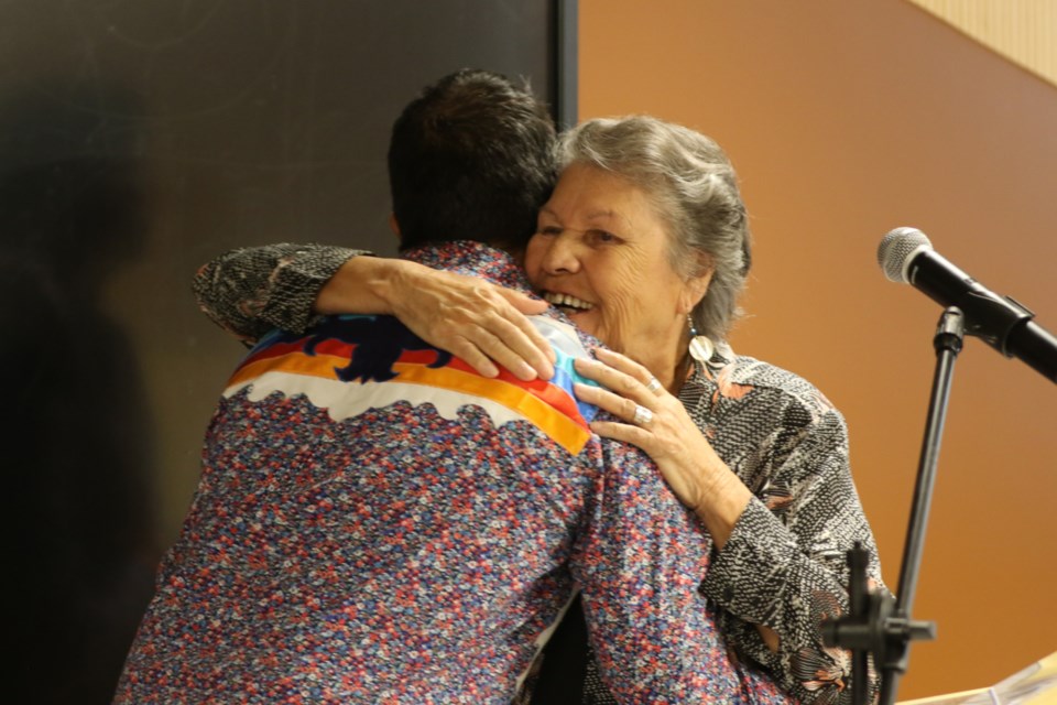 Children of Shingwauk Alumni Association co-founder Shirley Horn shares an embrace with Makwa Waawaa'igan Director Joel Syrette after Sault MPP Ross Romano announced $2 million in provincial funding towards the construction of the $43.3-million building at Algoma University during an event held at the university Aug. 28.