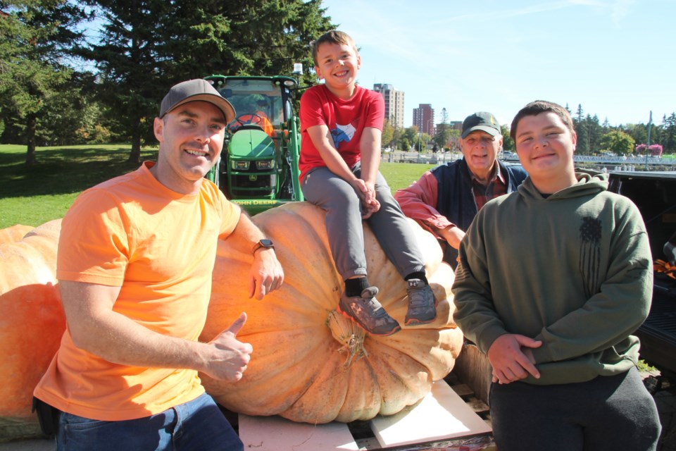 Brent Rouble, nephews Nash Caldwell (seated on pumpkin), Dane Rouble and father Steve Rouble at rear with Brent’s first place-winning 636-pound pumpkin after the Algoma Farmers Market’s annual Giant Pumpkin Weigh Off, Oct. 5, 2024.